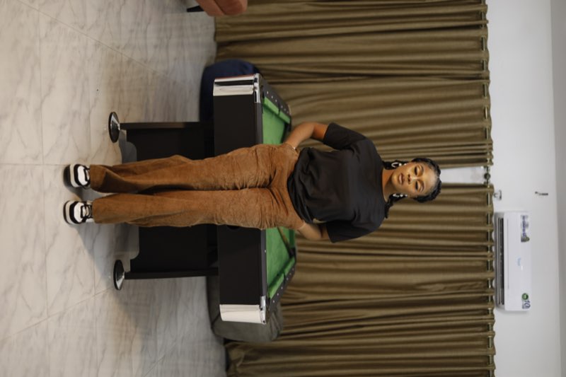 Black oversized T-shirt with tan suede wide-leg pants casual chic by best tailor Enugu