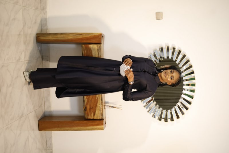Navy button-down tunic dress with matching wide-leg trousers and silver clutch by fashion designer Enugu
