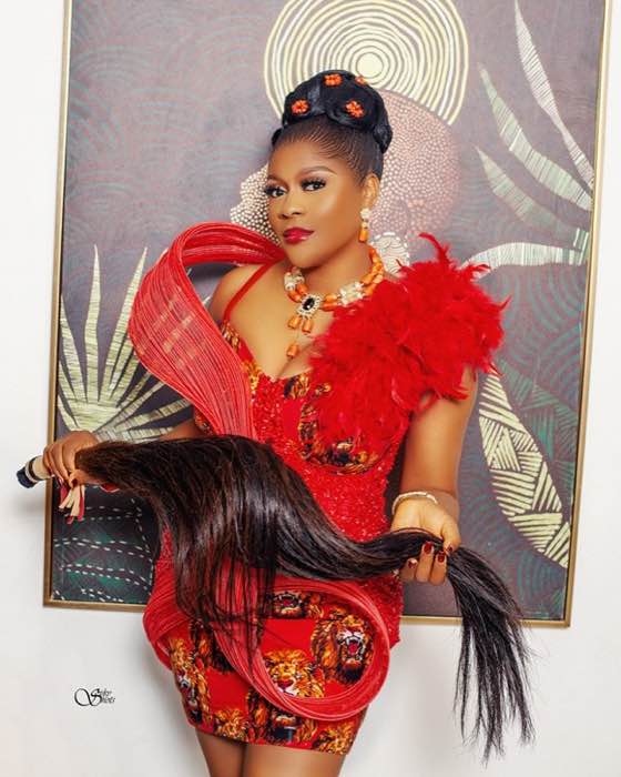Red feathered Ankara short dress with organza draping and coral beads by best tailor Enugu