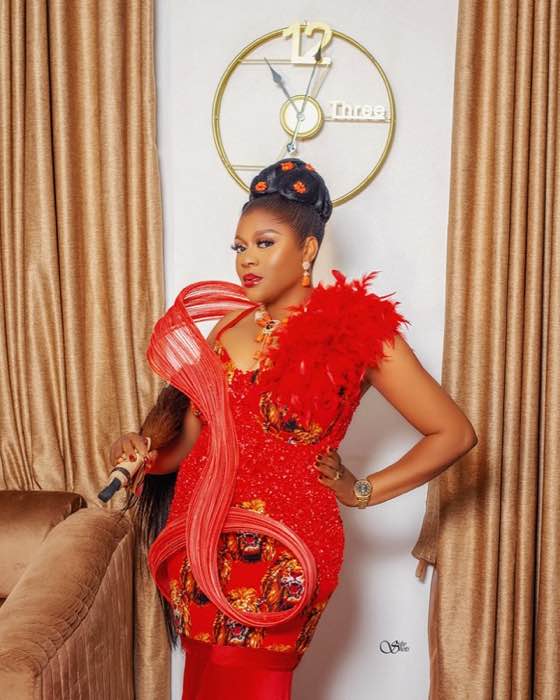 Red feathered mermaid gown close-up standing pose by fashion designer Enugu
