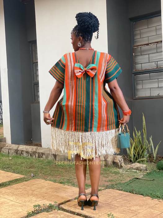 Orange and green striped fringe mini dress back view with bow detail by fashion designer Enugu